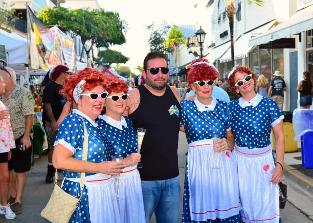 A pack of wild Lucille Balls poses with a guest at Fantasy Fest, the most inclusive of all the festivals in South Florida.