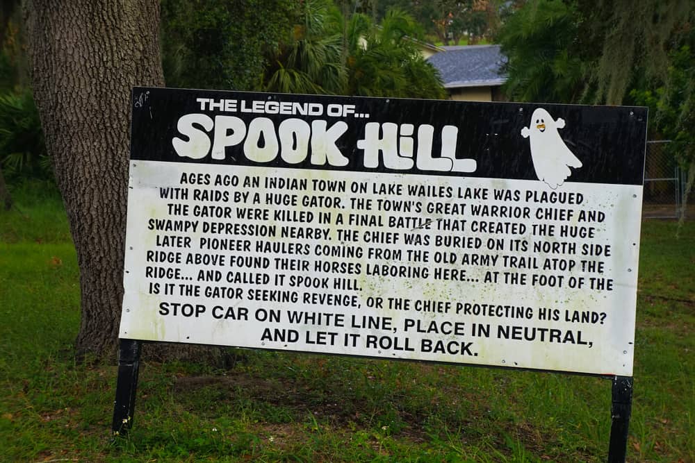 Photo of sign explaining the legend of Spook Hill, one of the most haunted places in Florida. 