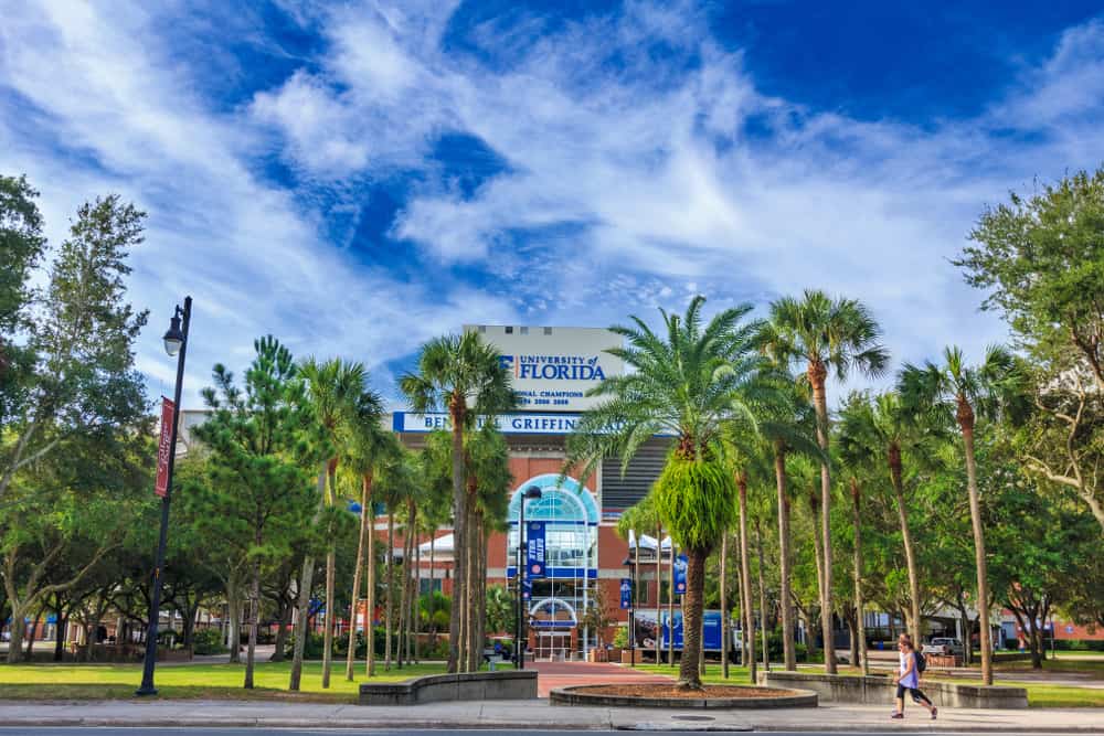 Entrance to the Ben Hill Giffin Stadium on the campus of University of Florida with many palm trees.