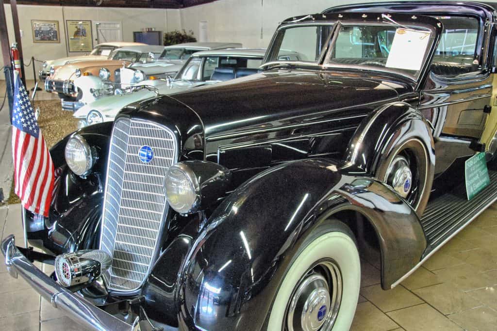 A row of classic cars lines the showroom at the Sarasota Classic Car Museum, one of the great things to do in Sarasota.