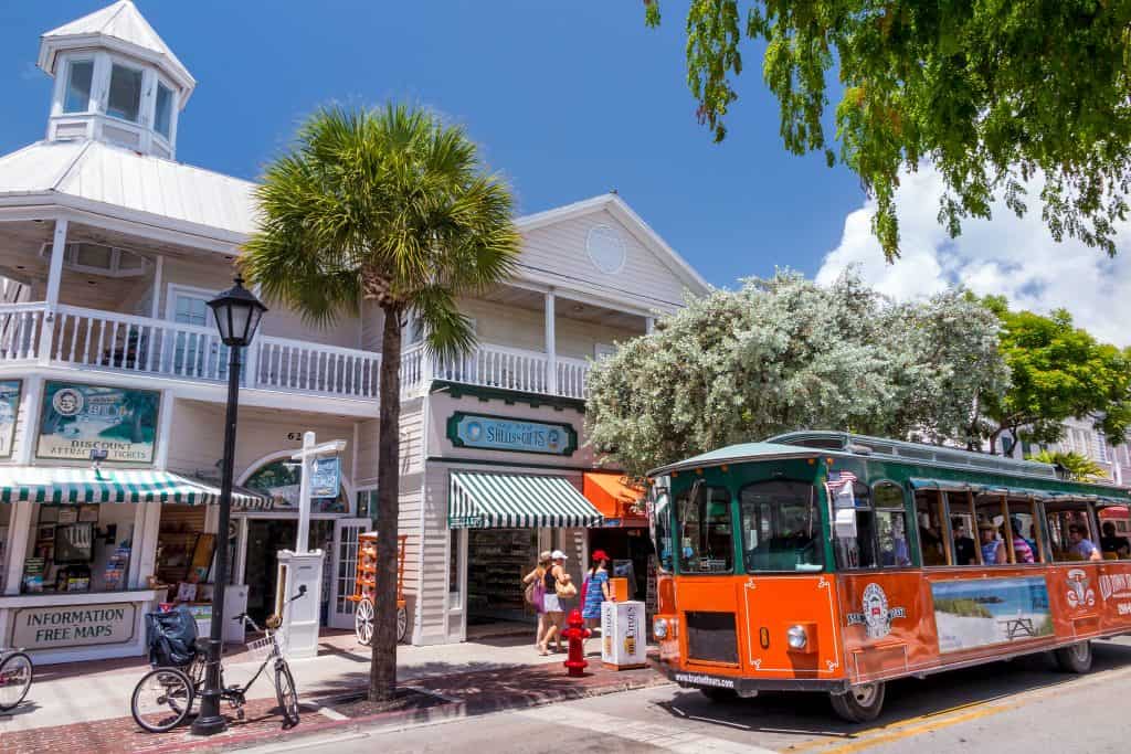 Photo of Downtown Key West with a red trolley. 