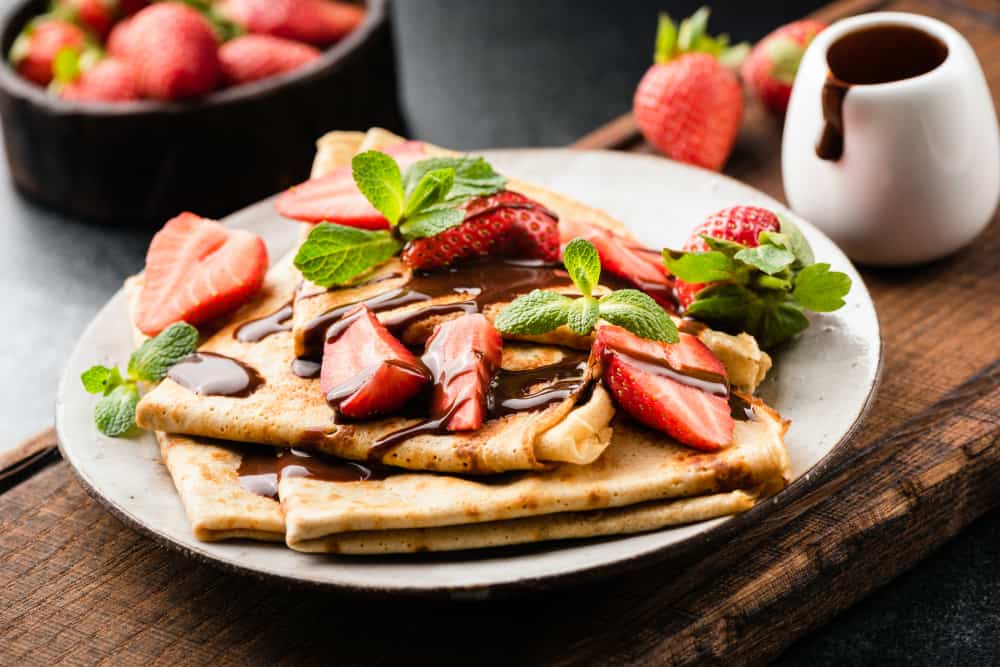 Plate of strawberry and Nutella crepes.