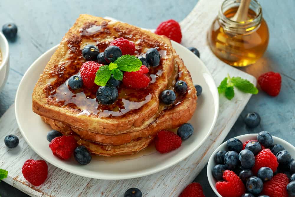 Fluffy French toast with honey and berries.