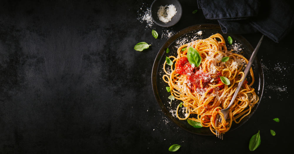 bowl of pasta garnished with basil leaves