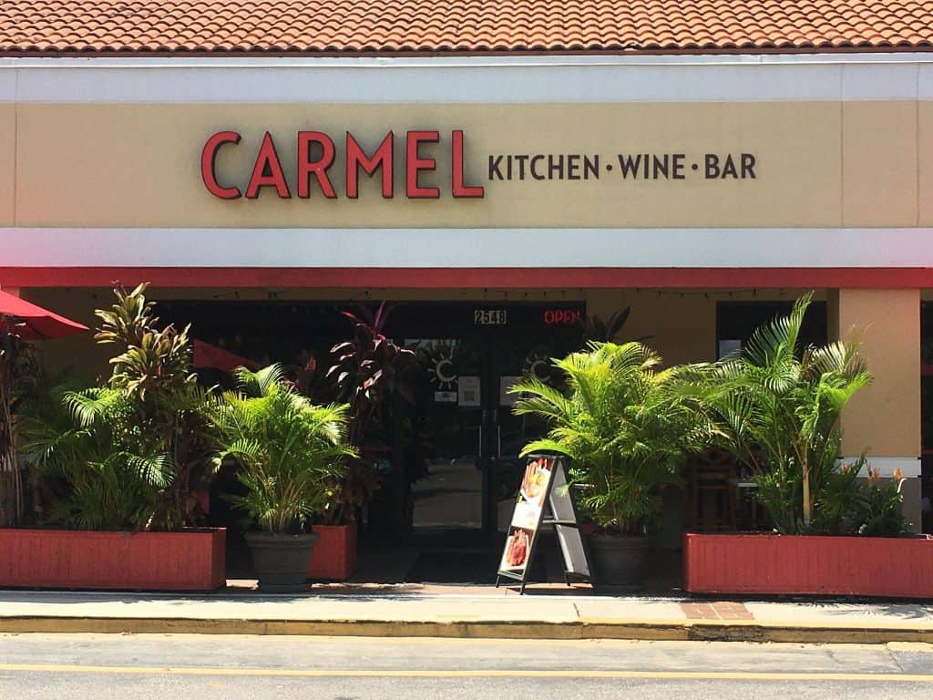 Lush plants surround the patio at Carmel, one of the best restaurants in Clearwater, Florida.