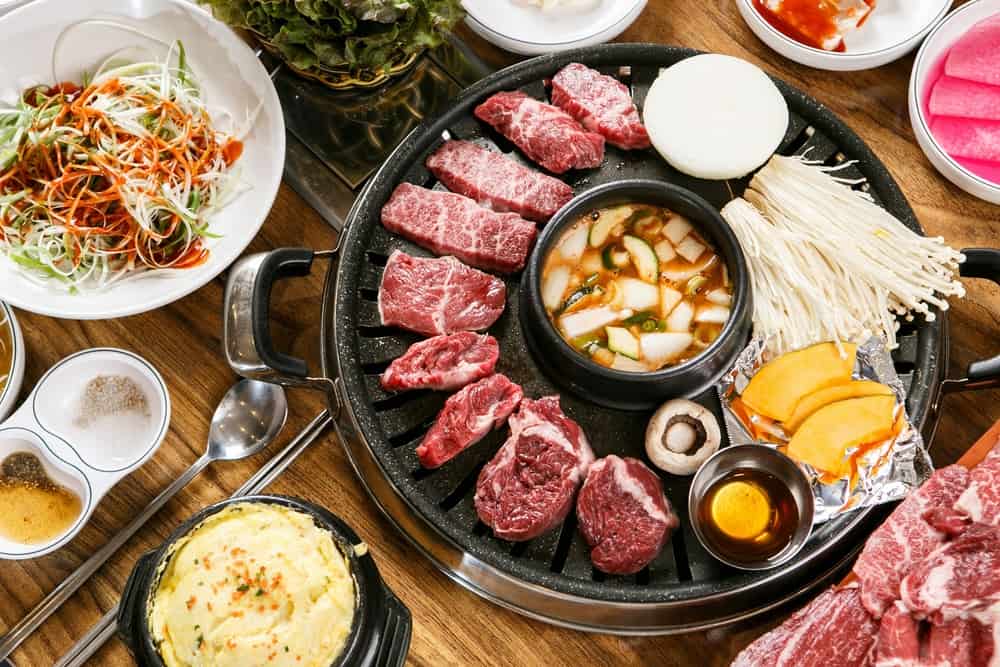 This Korean BBQ restaurant you will cook your on food on a grill located in center of the table!