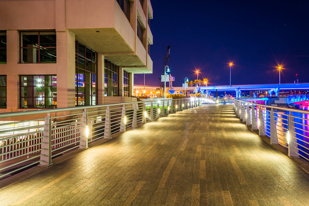 The Riverwalk at night, in Tampa, Florida. The article is about  best restaurants in Tampa