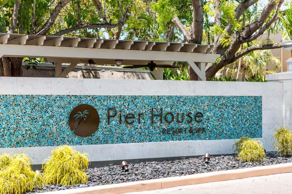 The blue and white glass-tiled sign welcoming guests to the Pier House