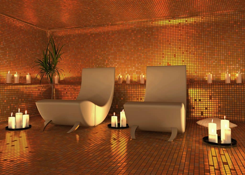 Two lounge chairs surrounded by relaxing candles in a relaxation room.