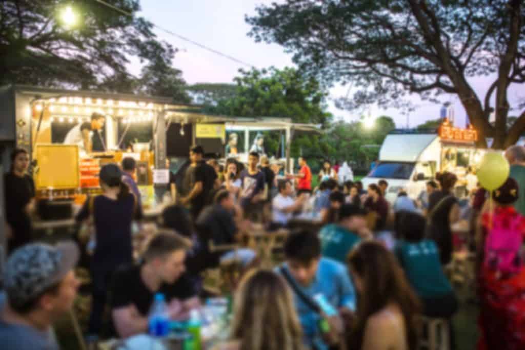 Crowds swarm to get quick bites from a food truck at the Food Truck Bazaar in Orlando, Florida.