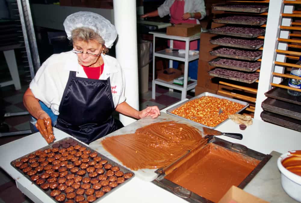 A woman making chocolate at Angell and Phelps Chocolate Factory.