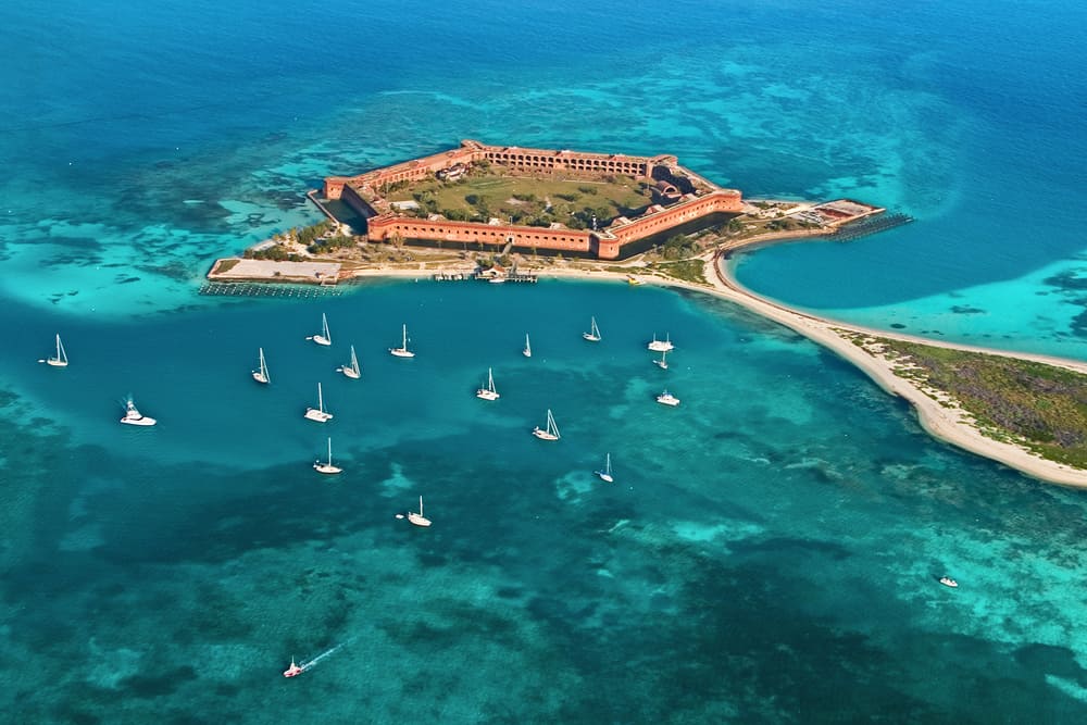 Aerial view of Fort Jefferson and surrounding waters of the Dry Tortugas National Park, where you can encounter wild sea turtles in the Florida Keys. 