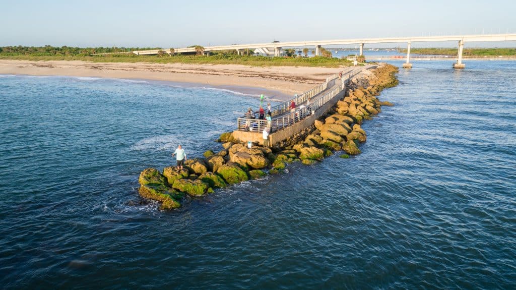 Aerial image of fishermen casting their lines off the jetty at Sebastian Inlet State Park.