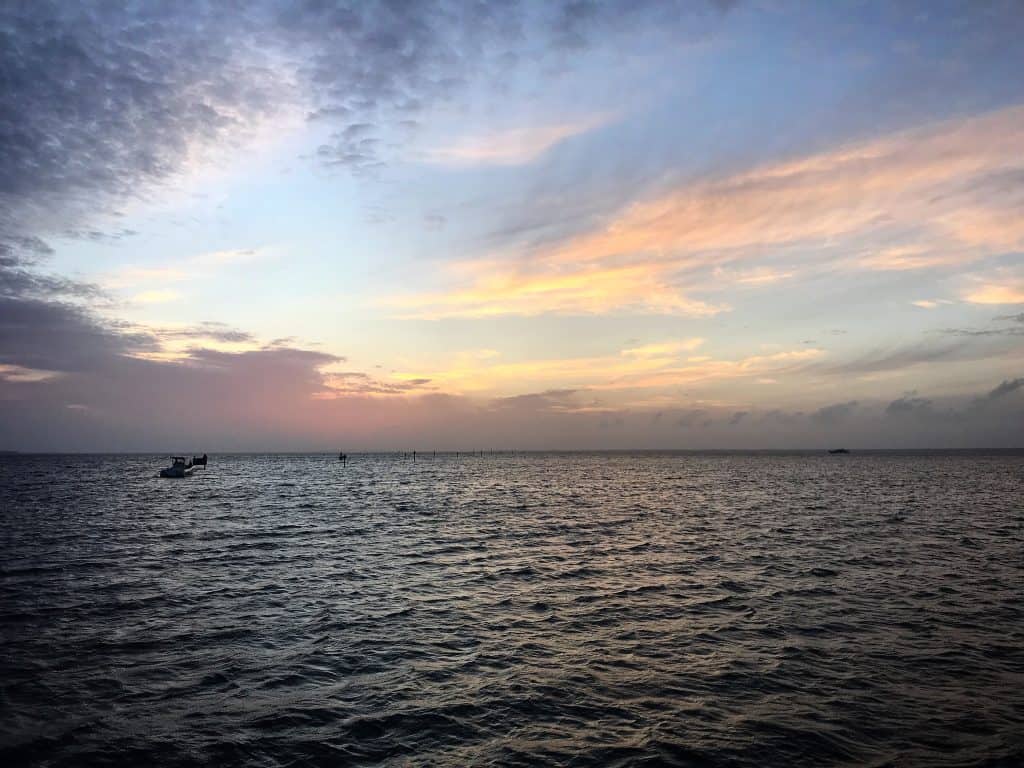 The view of the ocean sunset from the pier at Baytowne Wharf in Destin, Florida.