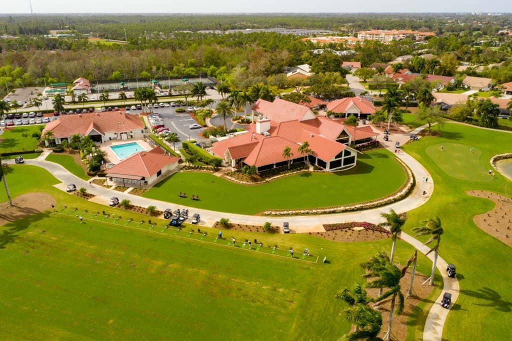 Aerial view of the fairways and clubhouse at Hibiscus Golf Club in Naples, Florida.