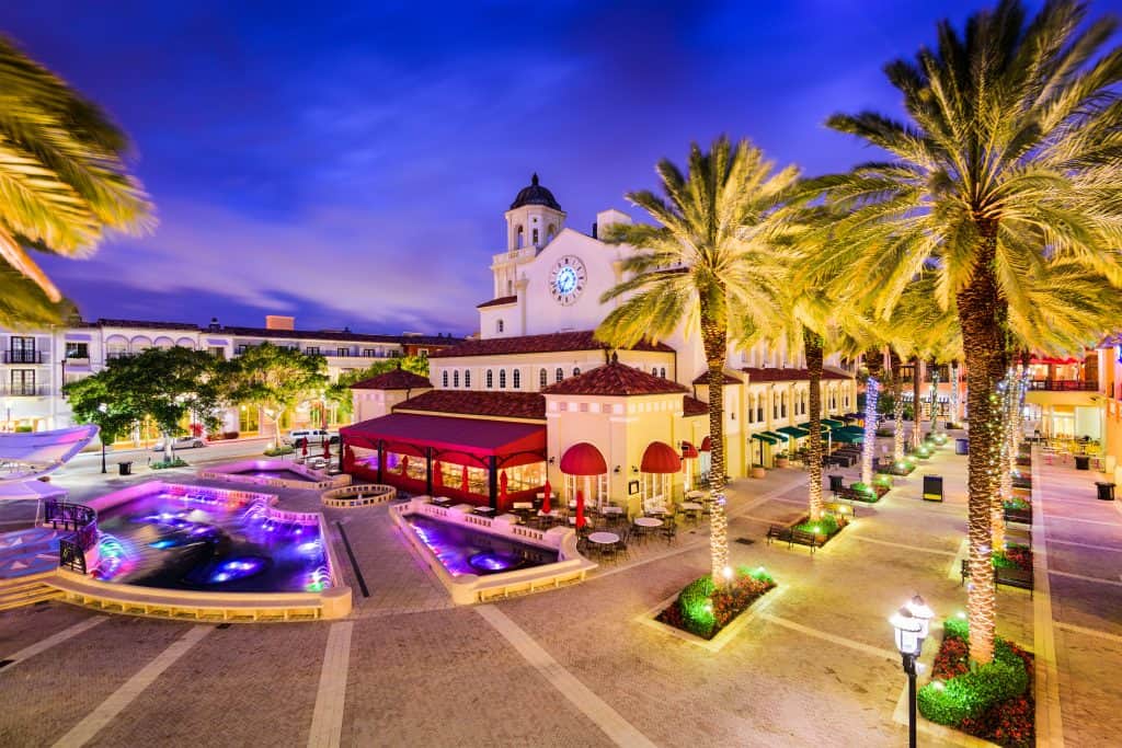 Rosemary Square in downtown at dusk with palm trees and fountains.