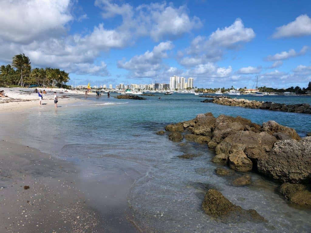 The beautiful rock formations that surround Peanut Island in West Palm Beach, Florida, with the city skyline in the distance.