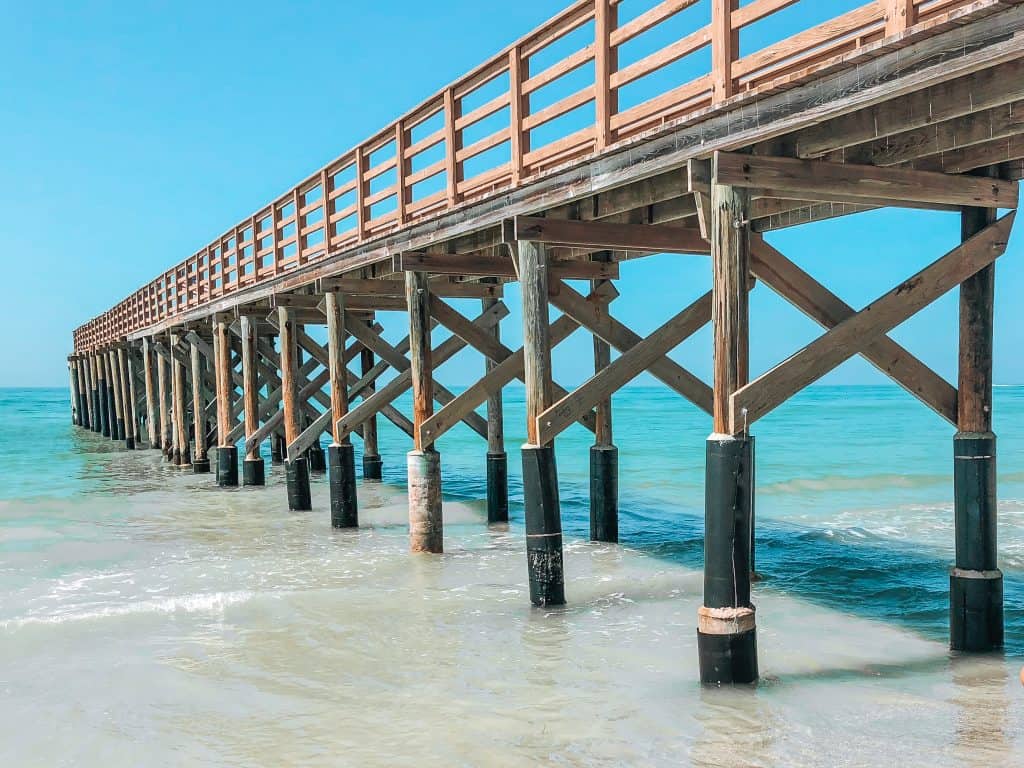 The waters lap at the pier on the shores of Redington Beach, one of the best beaches in Clearwater!