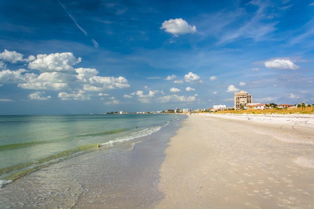 Gentle waves lap at the shores of St. Pete Beach, one of the best beaches in Clearwater and St. Petersburg Florida.