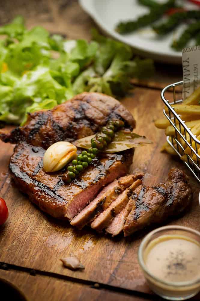 Food at the Edison is served on wooden cutting boards like the steak and friesor