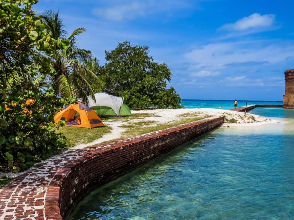 A tent sits right along the water's edge at Dry Tortugas, one of the most beautiful national parks in Florida. 