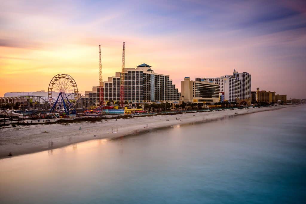 Sunset over the boardwalk and skyline at Daytona Beach, one of the best beaches in Florida.