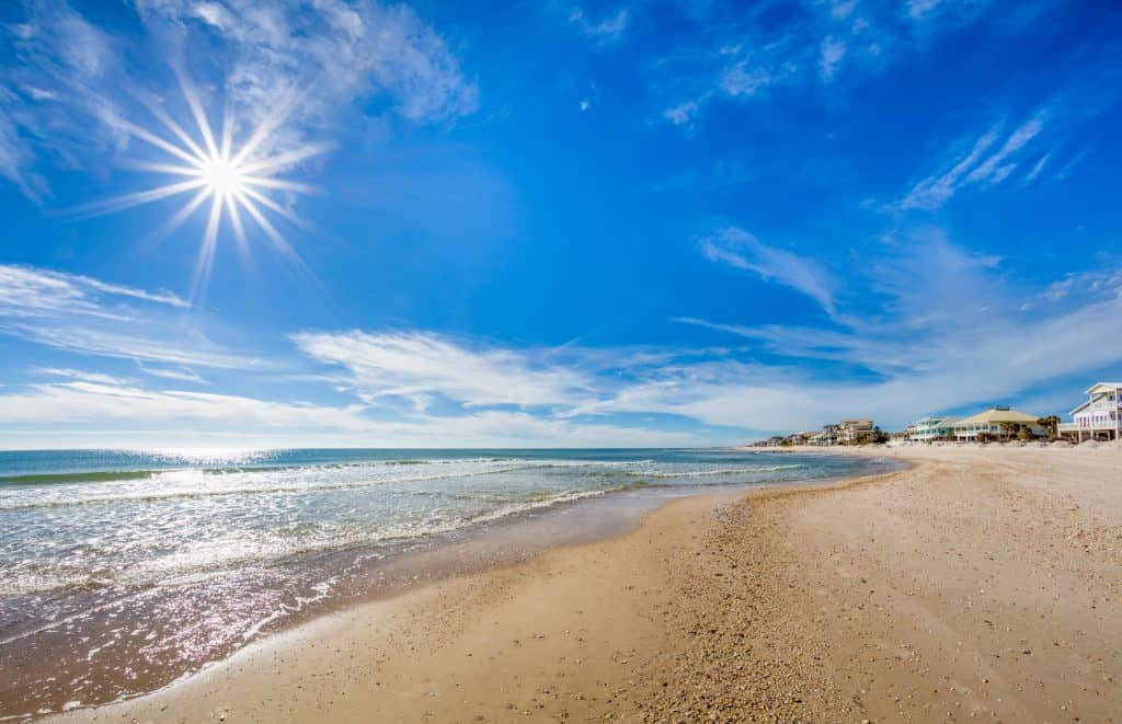 The waves gently wash up on the shore of St. George Island, one of the best beaches for families in Florida. 