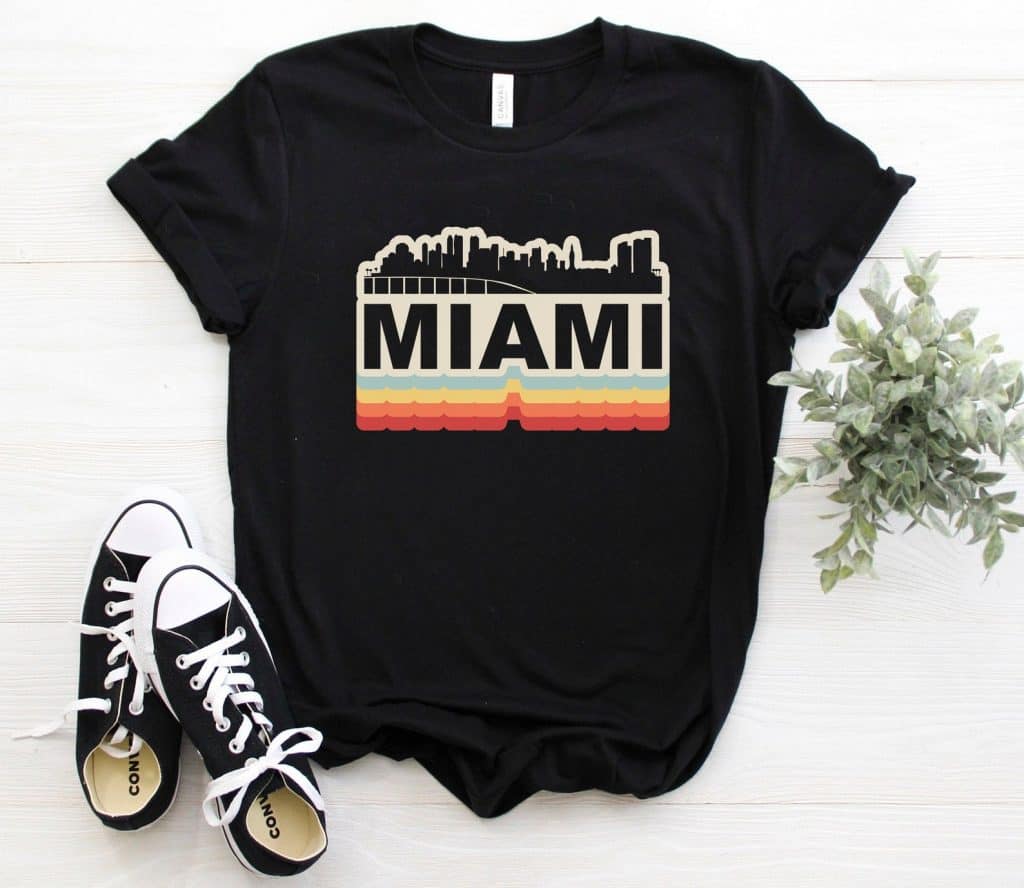 Photo of a black t-shirt featuring a retro Miami design, one of the best Miami souvenirs. 