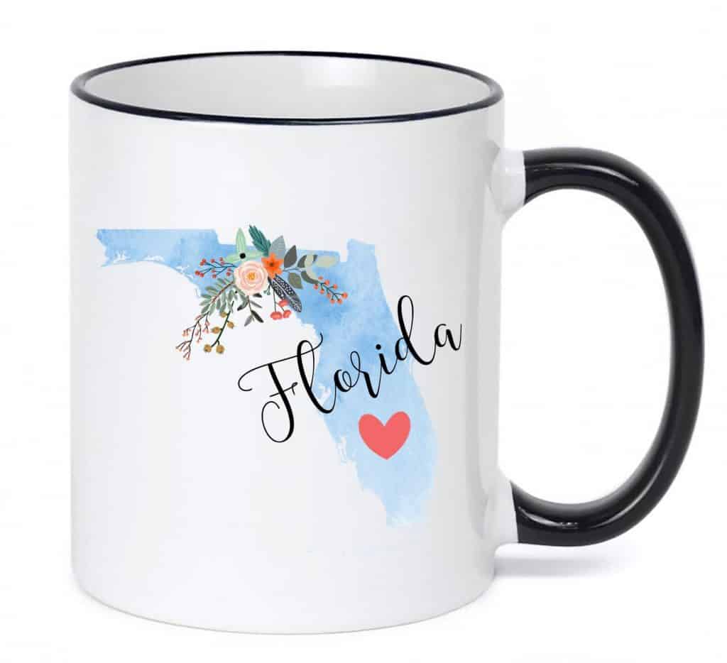 Photo of a white mug with blue ombre Florida decal, one of the best Florida gifts and souvenirs. 