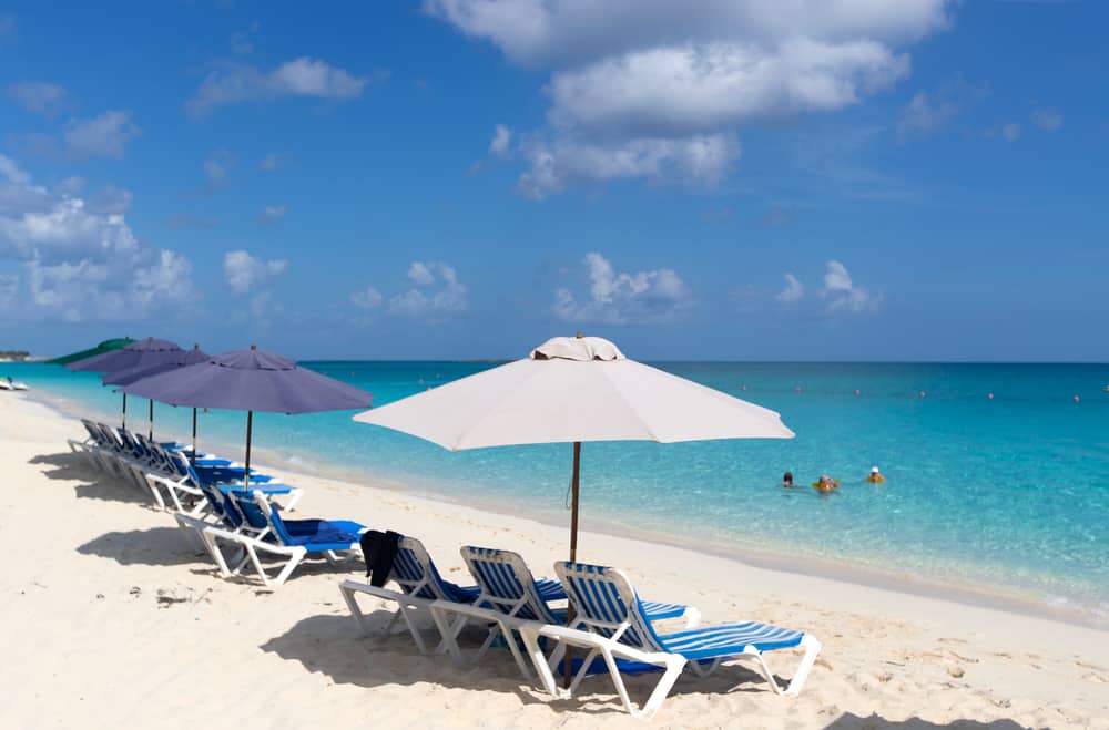 Photo of a beach in Sarasota with lounge chairs and umbrellas.