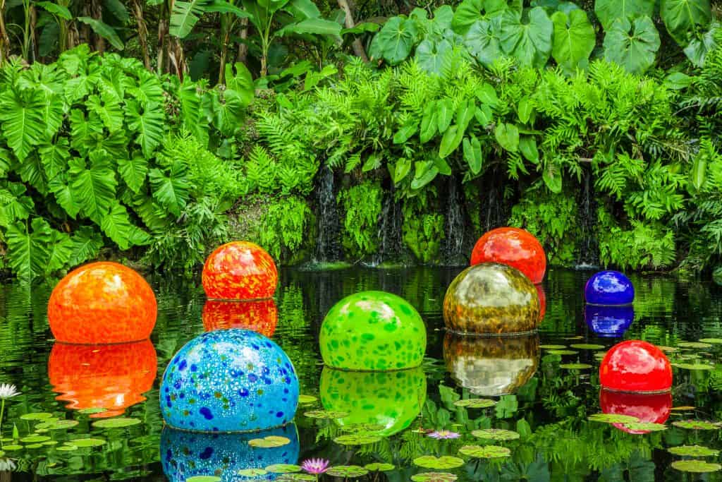 Glass orbs sit in a lily pond at the Fairchild Tropical Botanic Garden, one of the best things to do in Miami.