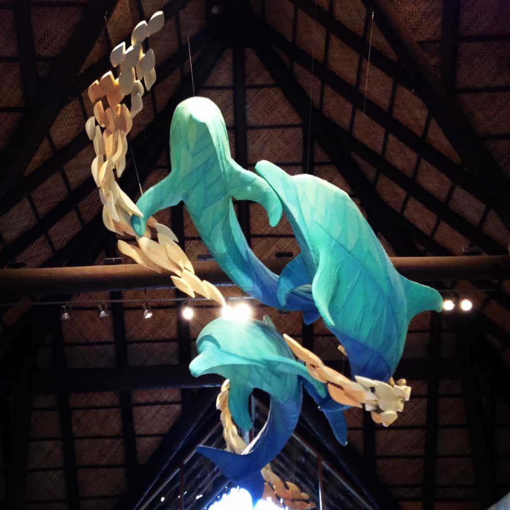 A large dolphin sculpture hangs overhead in the lobby of Discovery Cove, one of the best things to do in Orlando.