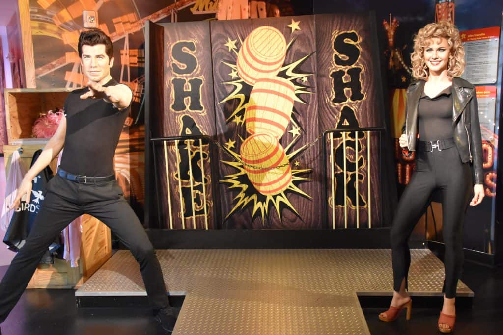 Realistic wax sculptures of Sandy and Danny from Grease stand in Madame Tussauds in Orlando.