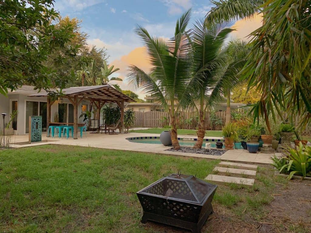 Photo of the lush backyard with swimming pool at an Airbnb in Sarasota.