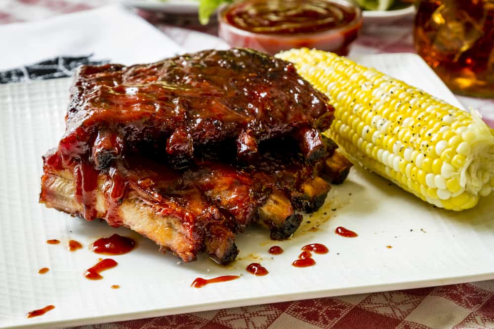 Plate of rubs and corn on the cob at one of the best BBQ restaurants in Saint Augustine.