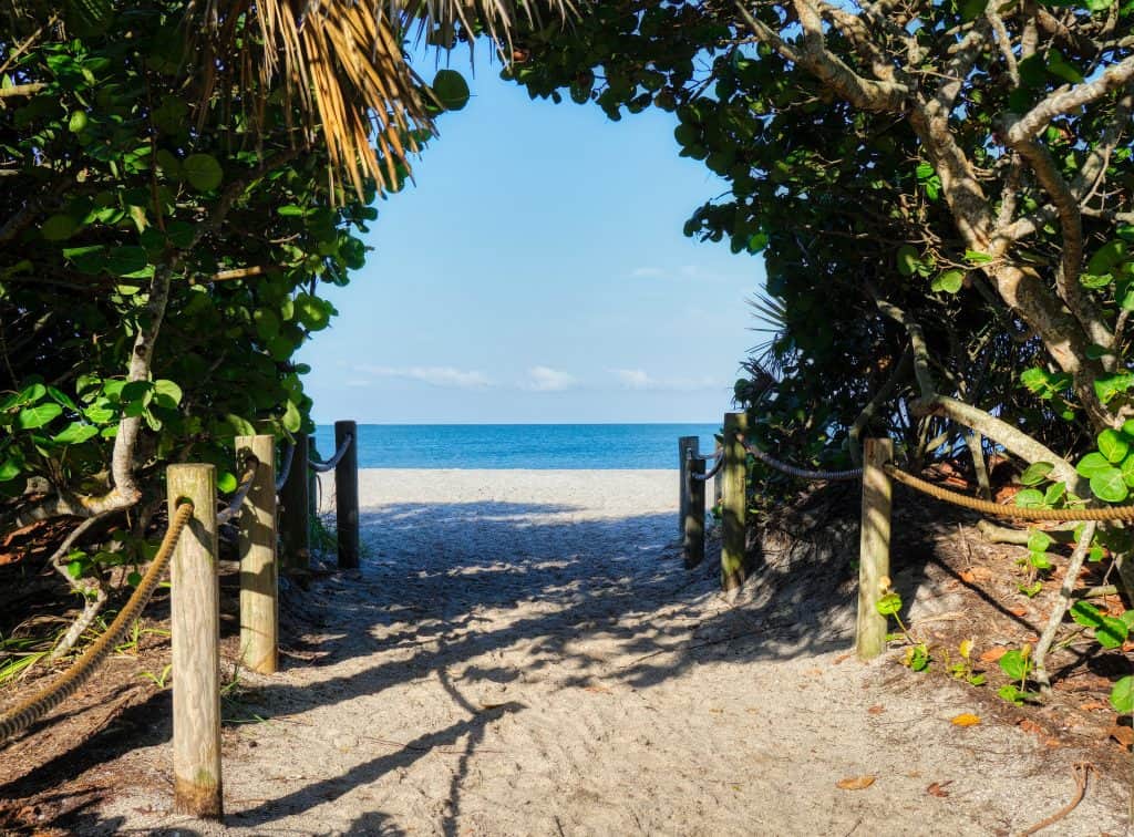 Mangroves and tropical trees create a tunnel that leads to the waters of Sanibel Island beaches.