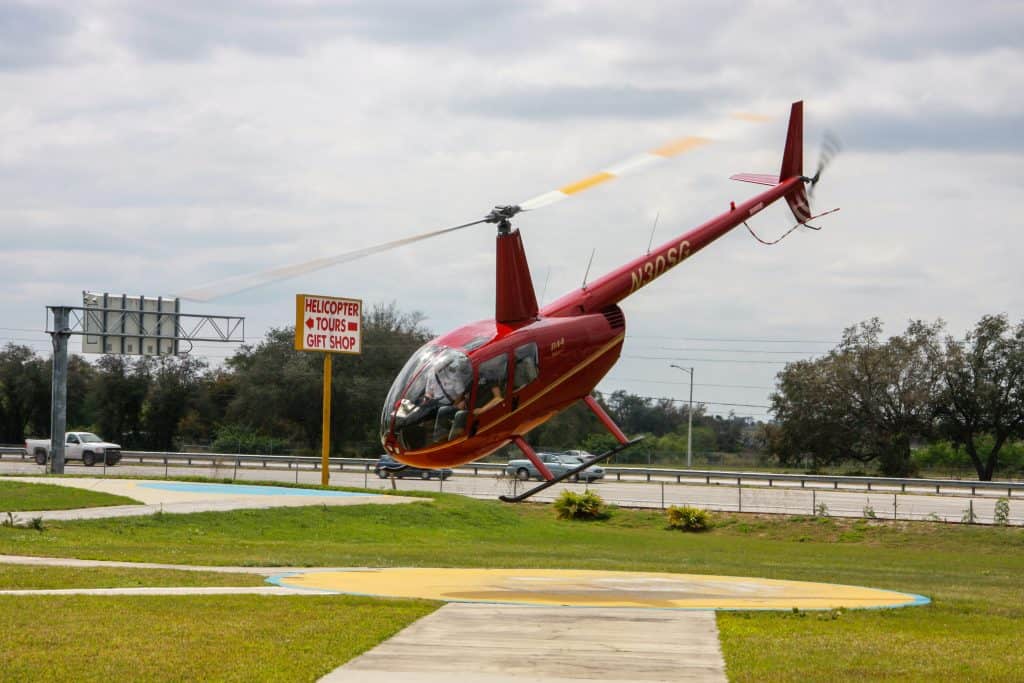 A helicopter lands at Orlando Heli-Tours, one of the best ways to see Kissimmee.