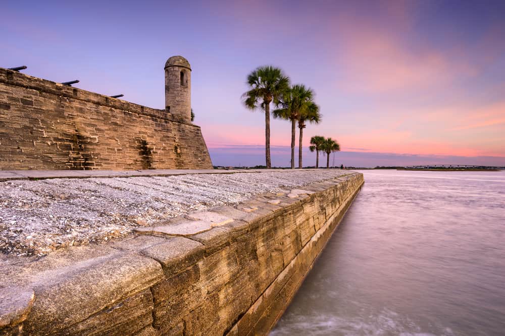 Pink sunset over Castillo San Marcos and the ocean.