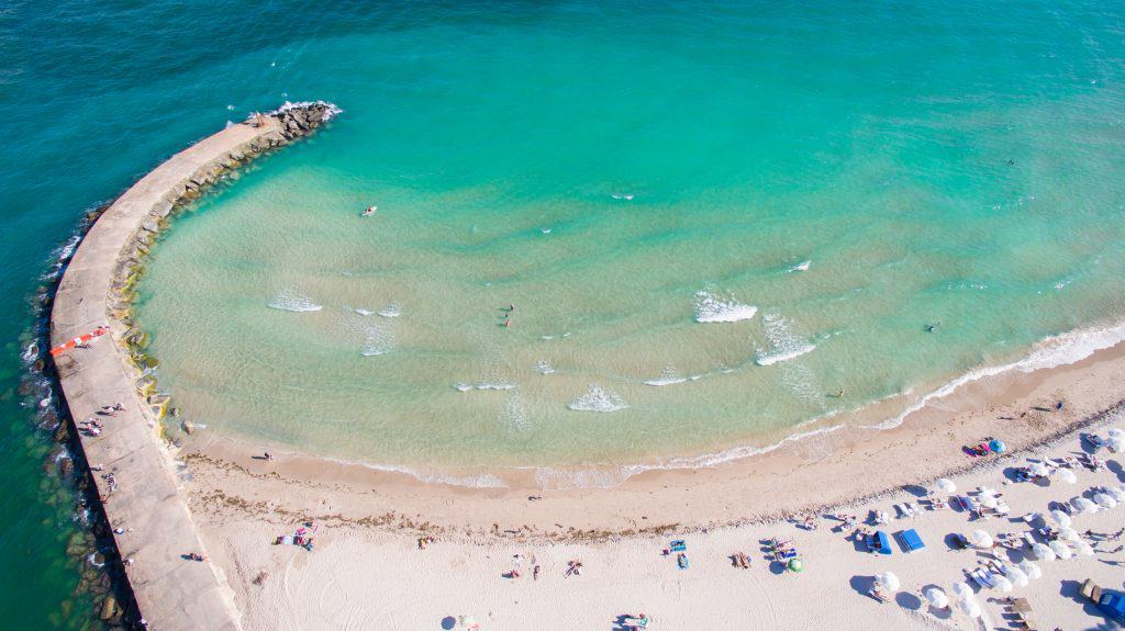 An aerial view of the clear blue waters of Haulover Beach, one of the best nude beaches in Florida.