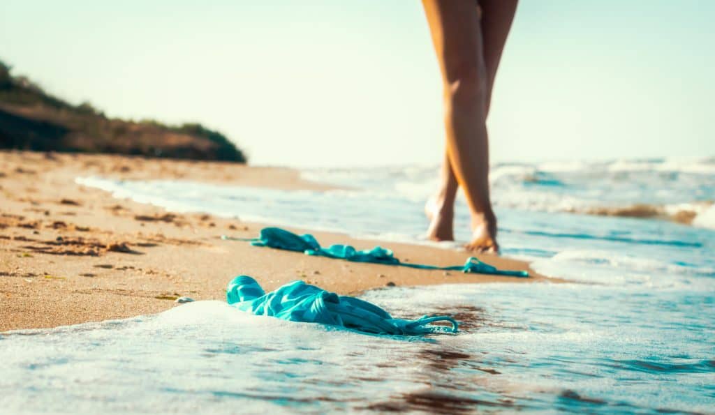 A woman sheds her bikini and walks on the best nude beaches in Florida.