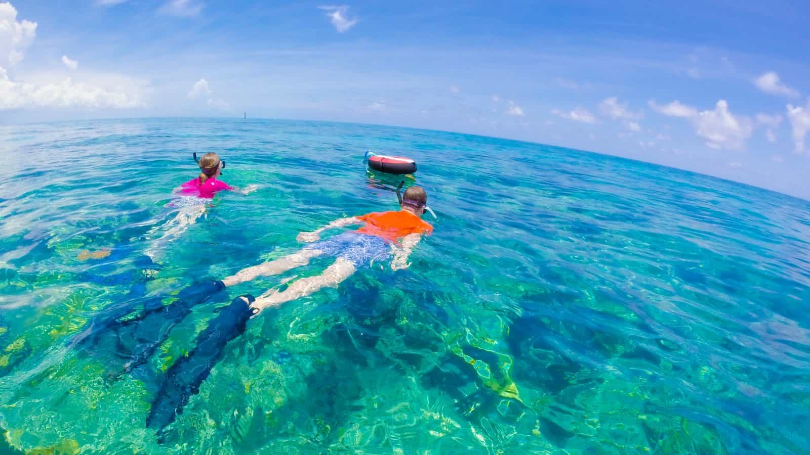 two people snorkeling off the coast of florida