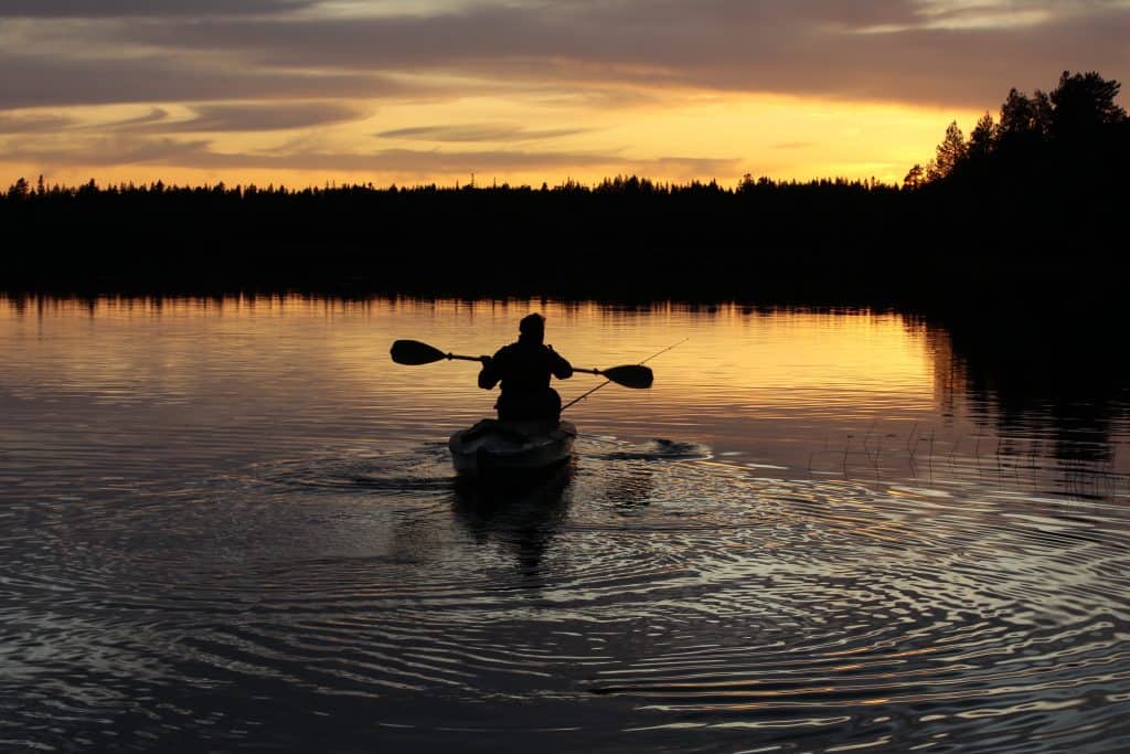 A paddler sets out during the sunset going bioluminescent kayaking in Florida
