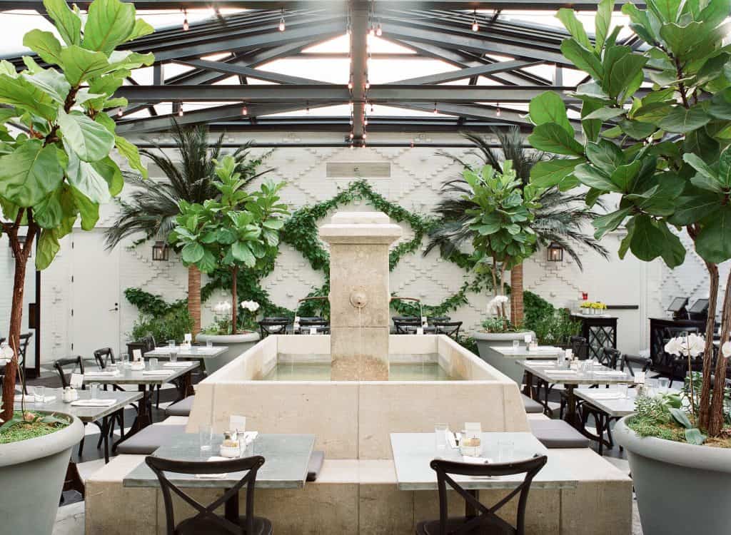 The garden dining area of Oxford Exchange, one of the best downtown Tampa restaurants, complete with its fountain in the center.