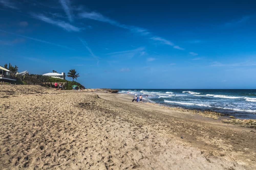 Jensen Beach with people enjoying the waves