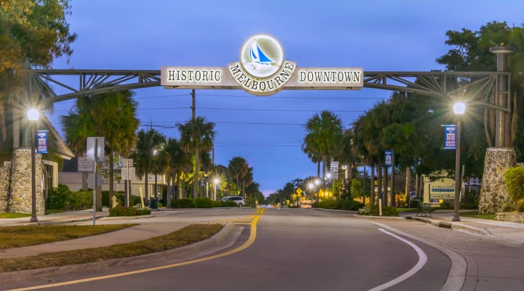 A quaint and jaunty sign covers the entrance to Historic Downtown, one of the best places to go in Melbourne, Florida.