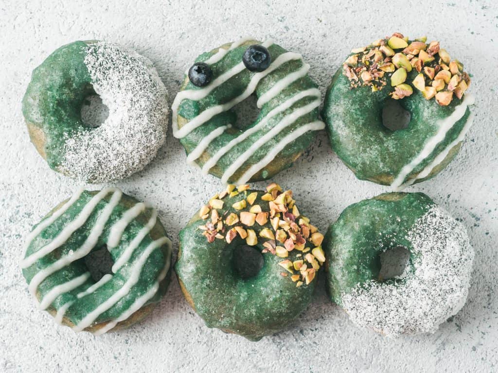Vegan donuts are sprinkled with pistachios and blueberries at a vegan bakery in orlando