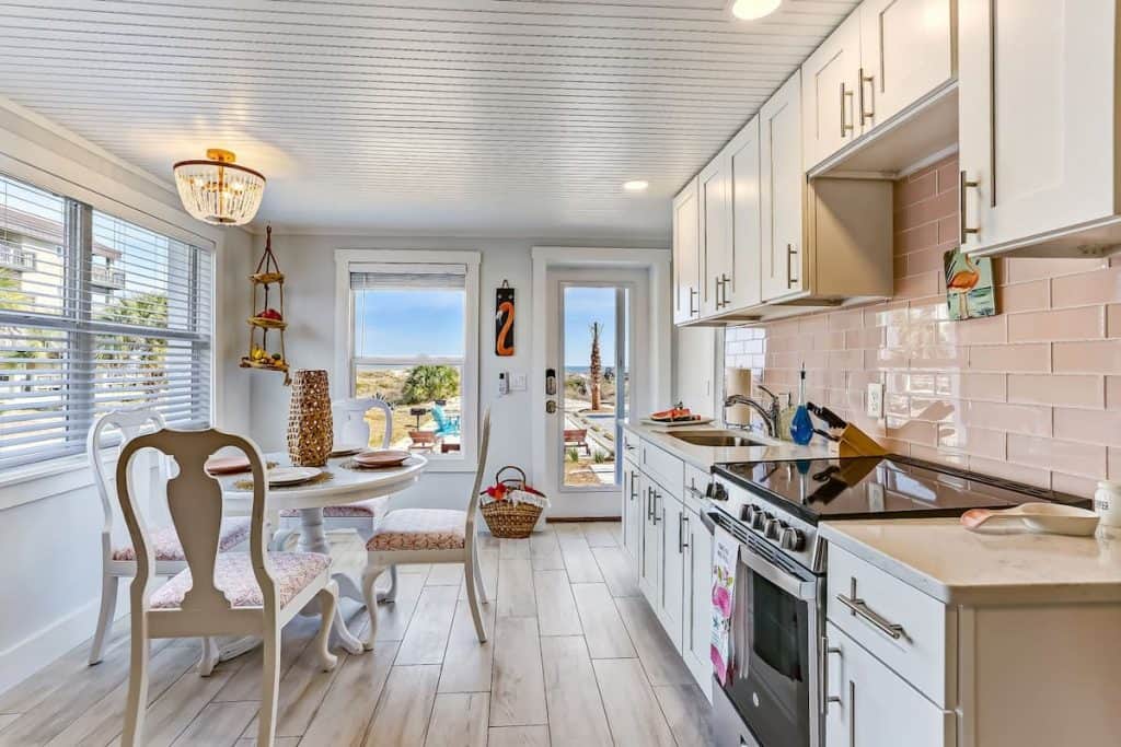 Photo of the kitchen and dining table inside a Florida Airbnb with a flamingo theme.