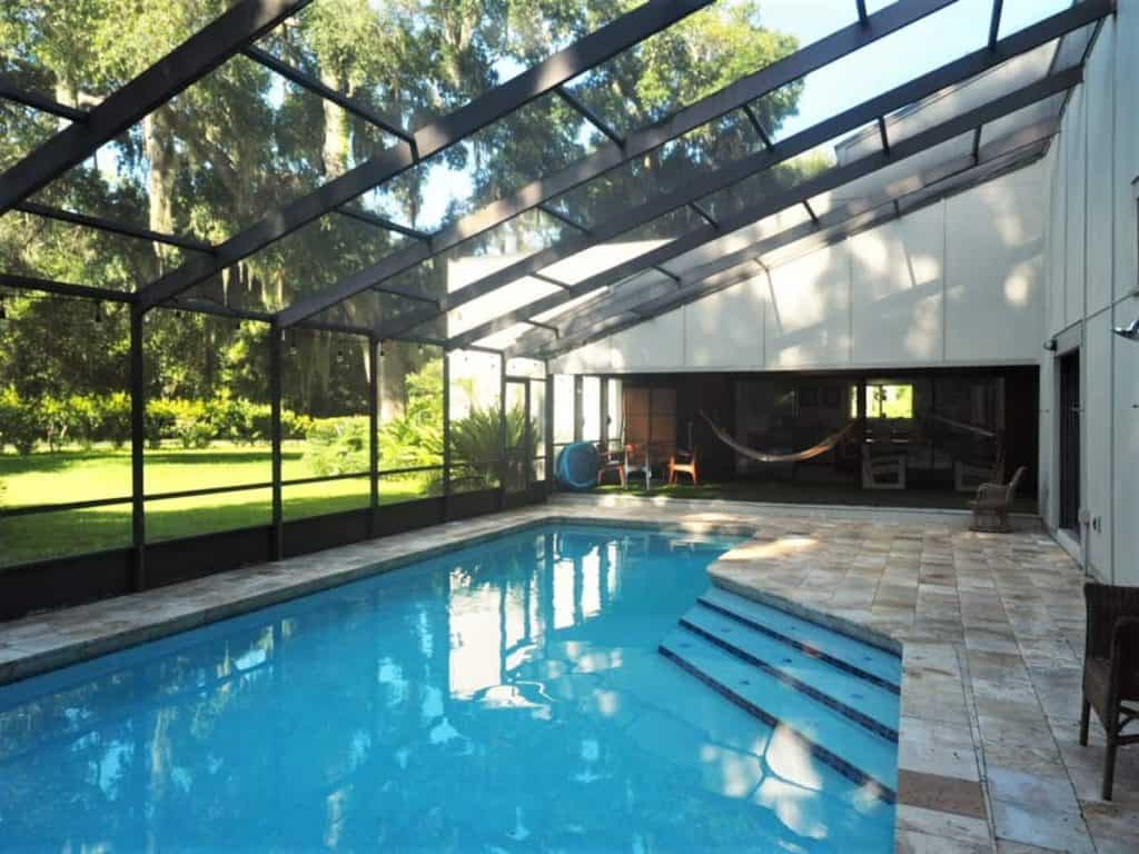 Photo of a large screened-in pool at one of the best Amelia Island Airbnbs.