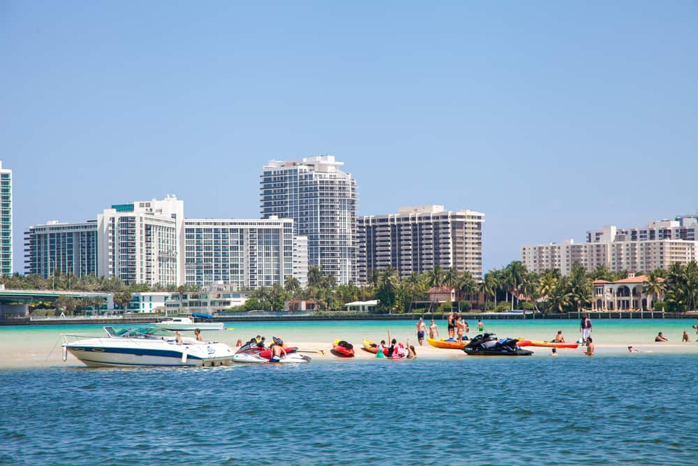 Boats and swimmers on a sandbar at Haulover Park Beach.