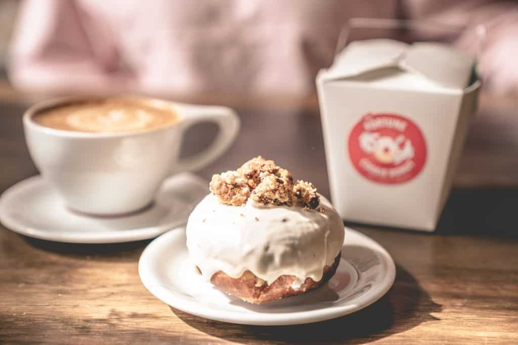 A cronut and a latte as served at the Salty Donut, one of the best coffee shops in Miami.